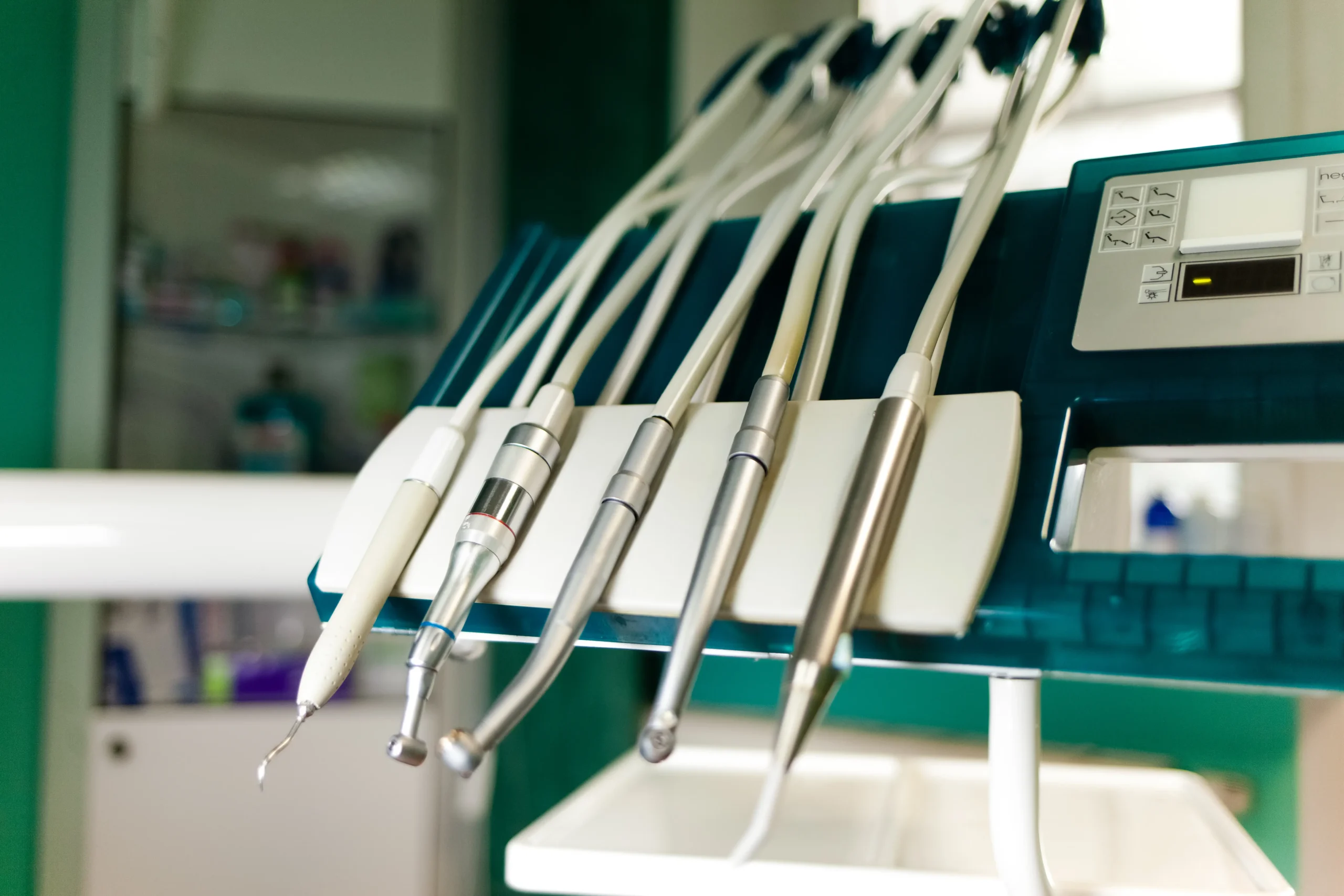 Close-up of modern dental instruments and handpieces on a dental unit, representing the advanced technology used for effective teeth cleaning in Abu Dhabi and comprehensive oral care.