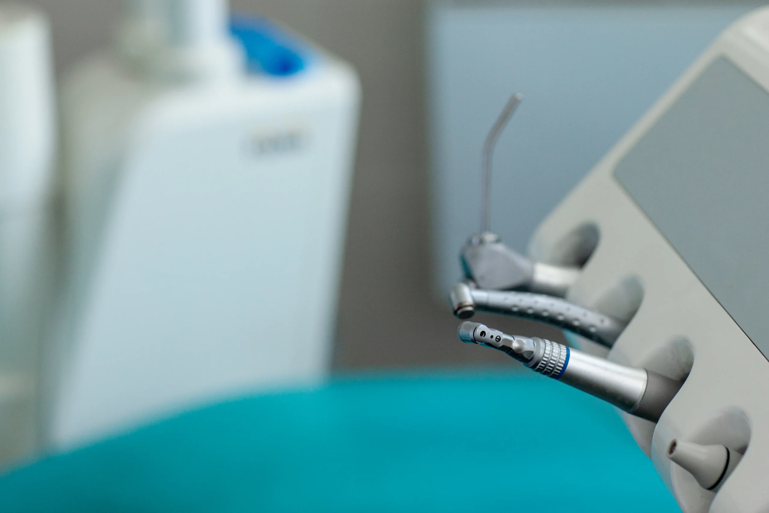 Close-up of specialized dental handpieces and instruments on a modern dental unit, representing the advanced equipment used for effective and precise root canal treatment in Abu Dhabi.
